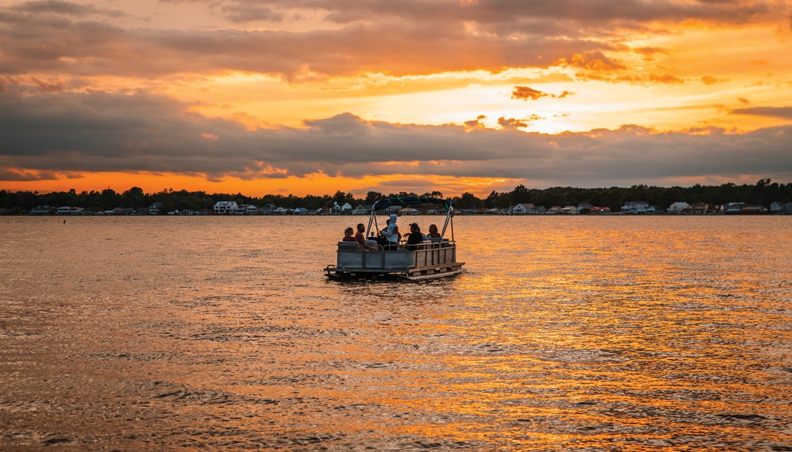 A pontoon overlooking a beautiful sunset on Buckeye Lake.