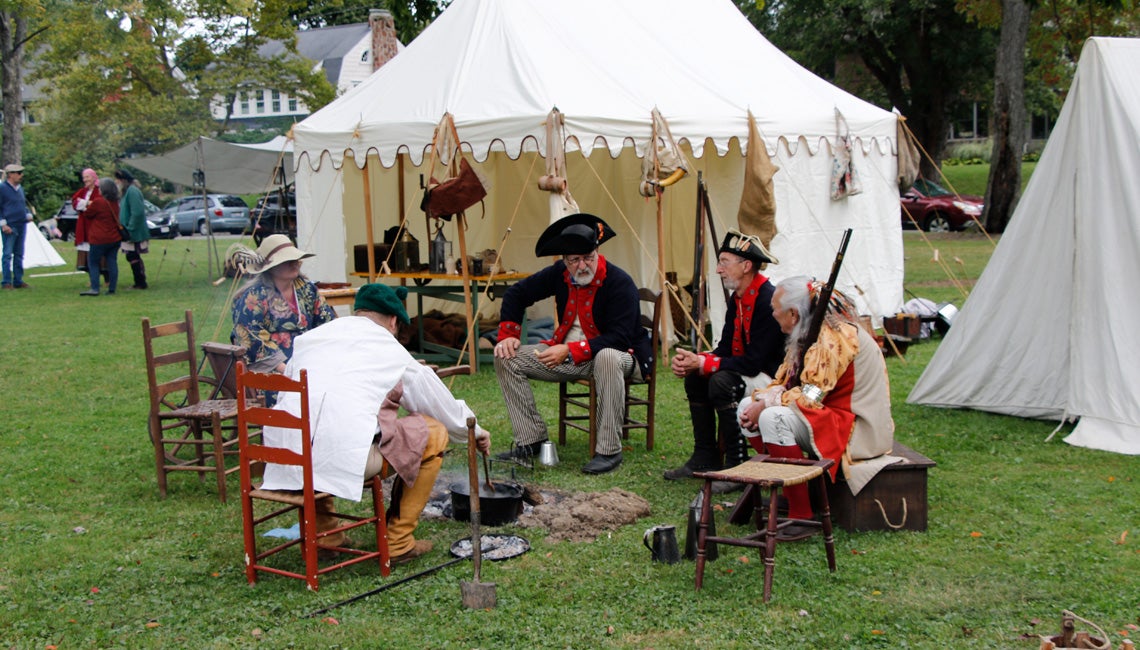 A group of people dressed in historical clothing for a reenactment