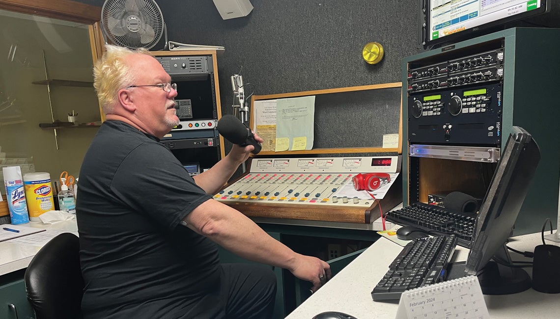 A man speaking into a radio microphone