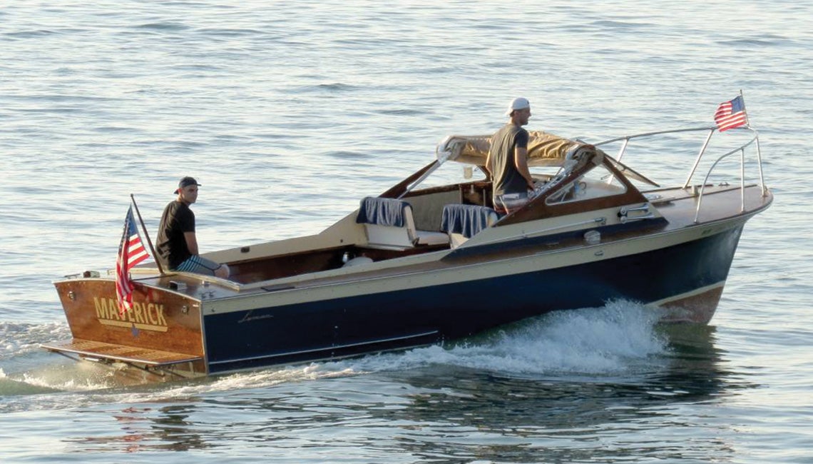 Two men riding on a boat in Lake Erie
