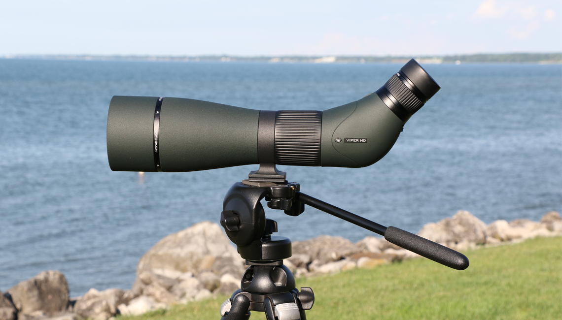 A telescope beside a body of water