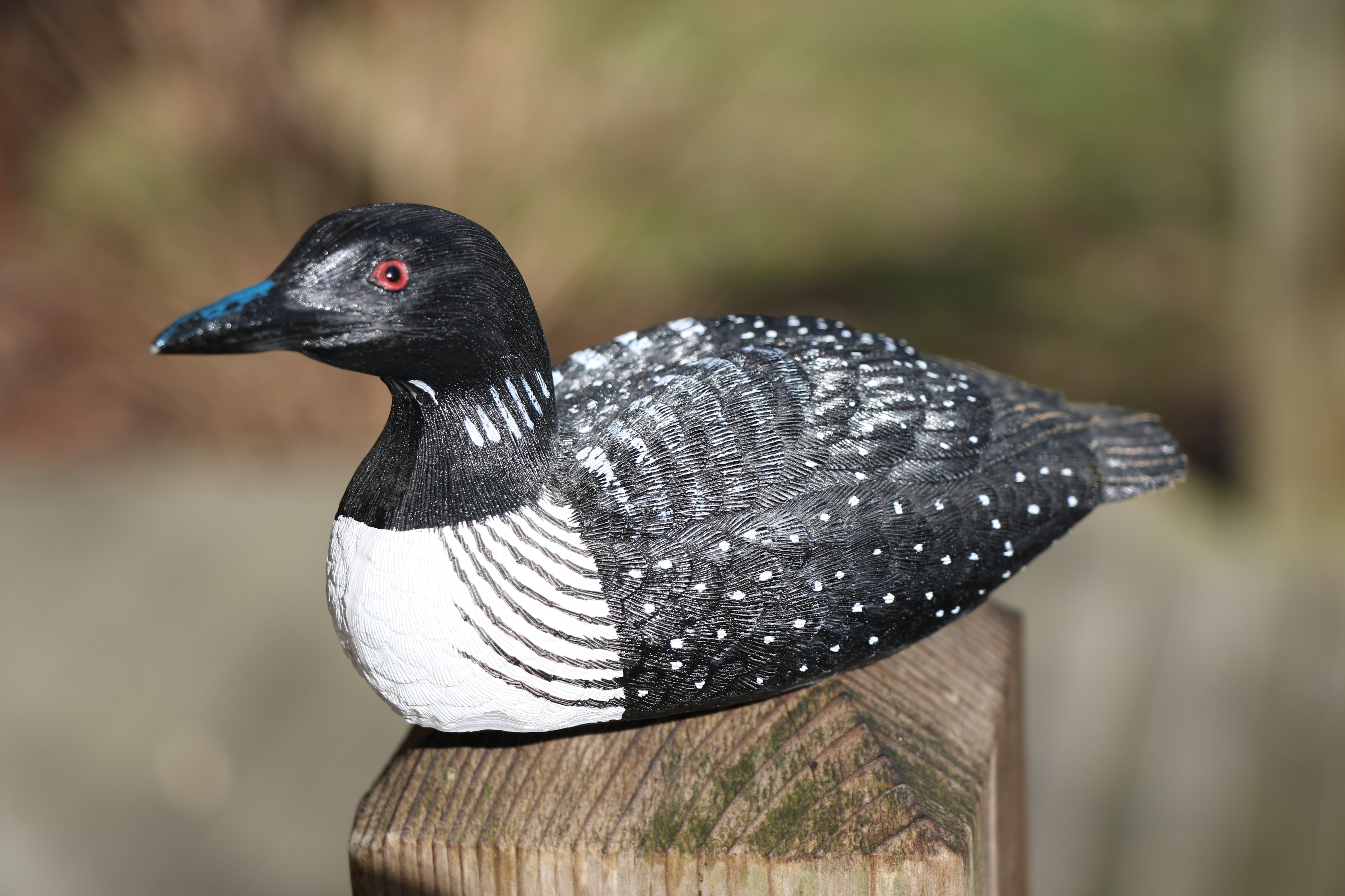 wood carving of black-and-white bird