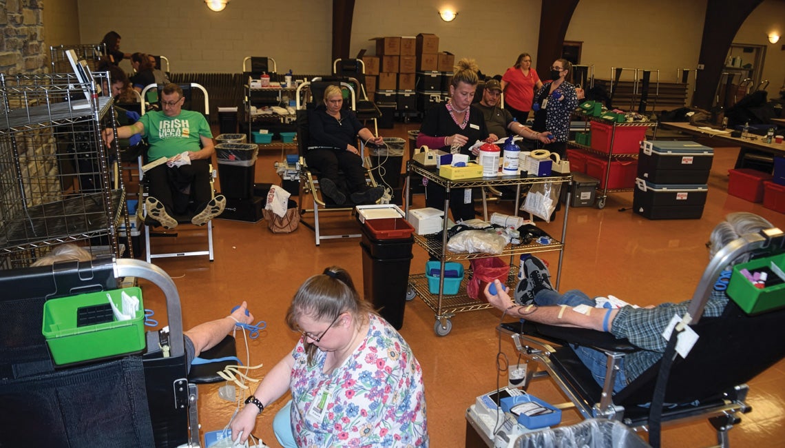 A group of people donating blood during a blood drive