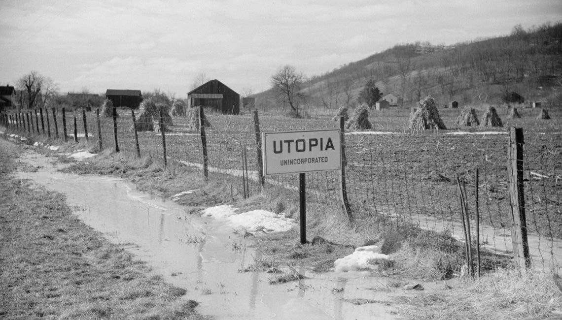 A black and white photo of a rural Ohio landscape with a Utopia city sign