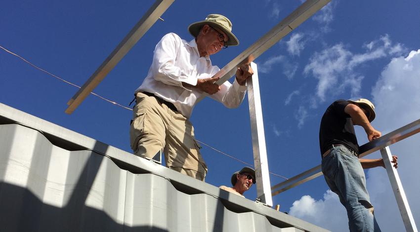 Tony Ahern, former CEO of Ohio’s Electric Cooperatives, holds a beam 