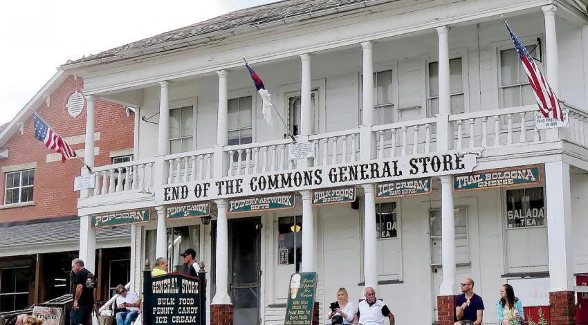 A picture of people sitting outside the End of the Commons General Store