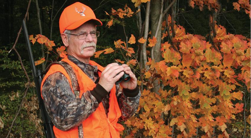 Rick Wilson pauses with binoculars in hand.