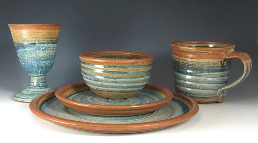 A collection of pottery bowls, plates, and cups.