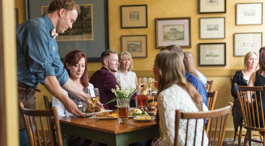 A picture of guests enjoying The Golden Lamb restaurant.