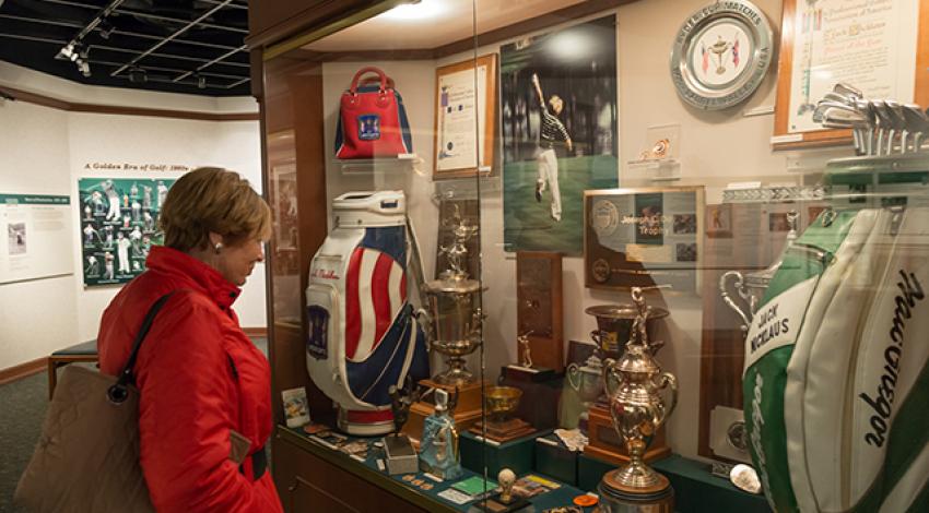 A woman examines a display at the Jack Nicklaus Museum