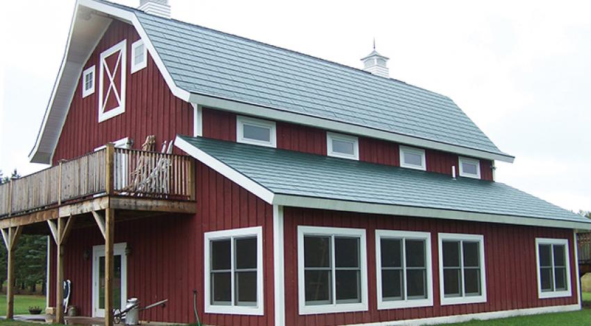 A large red barn with a metal roof.