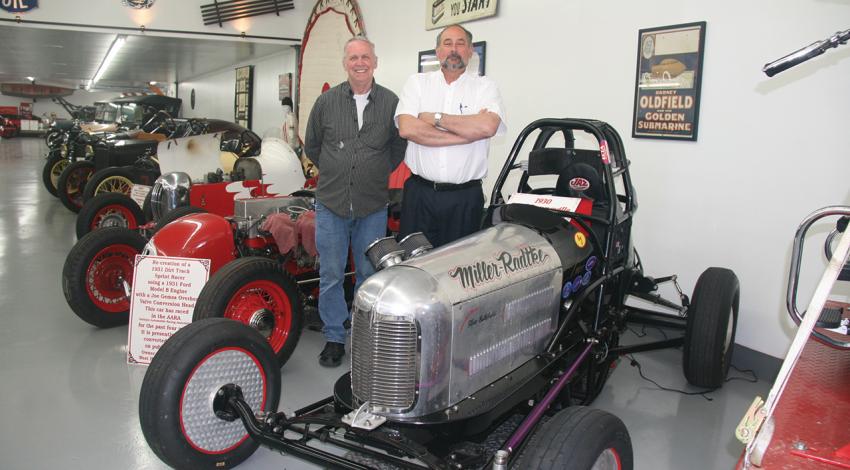 Ron Miller and Mark Radtke stand next to a Model A Ford-powered sprint car in the Salty Dog Museum.