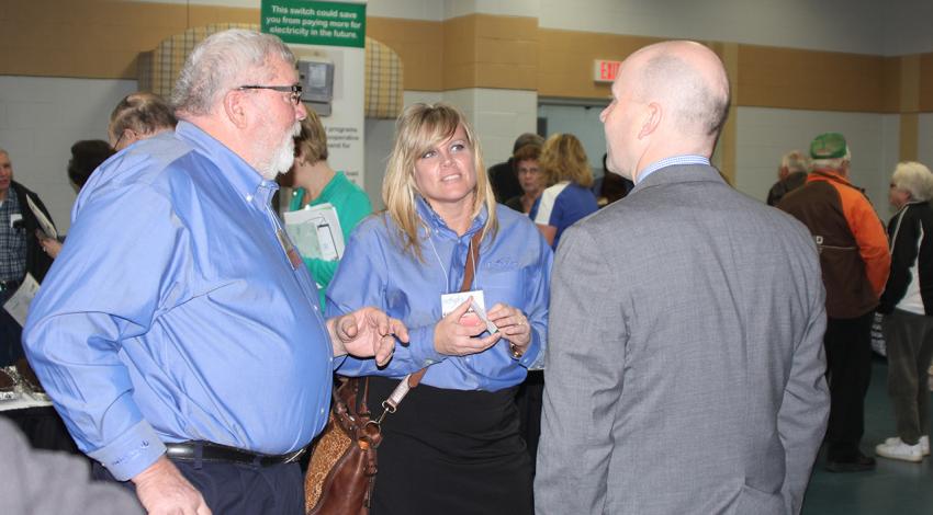 Colleen Eidemiller talks with two others.