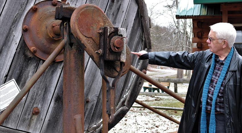 A man points to a part of the museum.