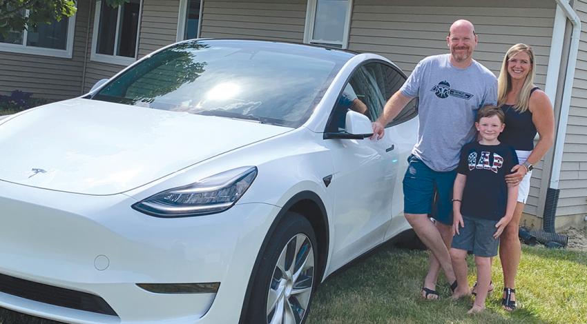 Huber family with their Tesla model Y
