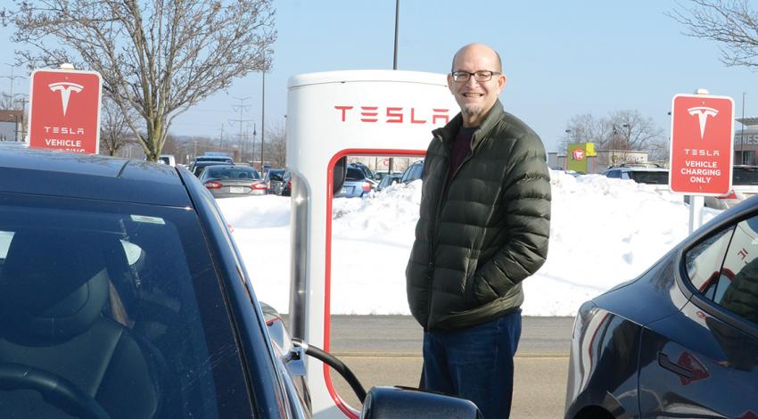 Jeff McCallister and an electric vehicle