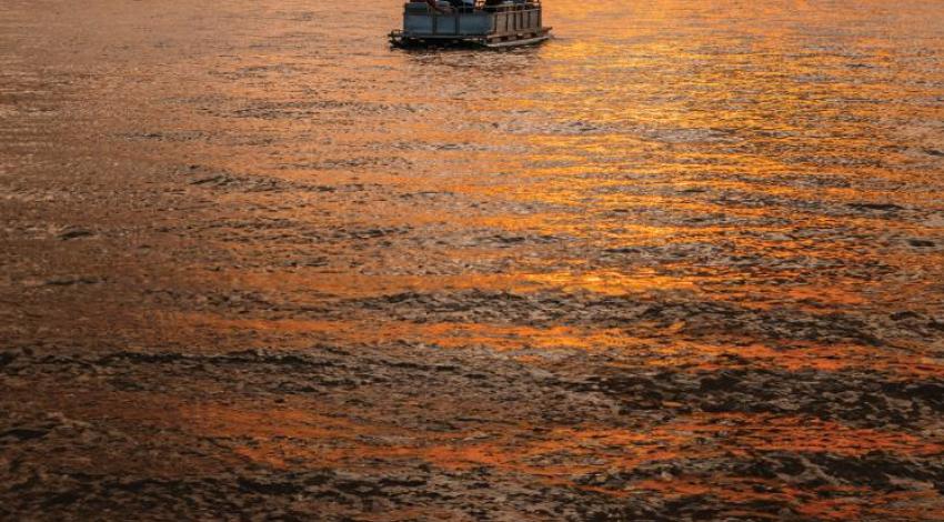 A pontoon boat overlooking a beautiful sunset on Buckeye Lake.