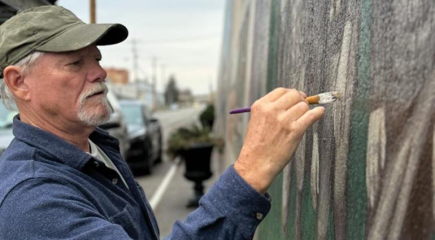 Robert Dafford working on a mural on Portsmouth, Ohio's, iconic floodwalls.