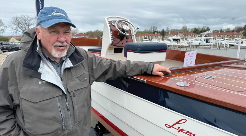 A man posing with a Lyman boat