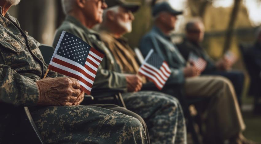 Veterans sitting with American flags
