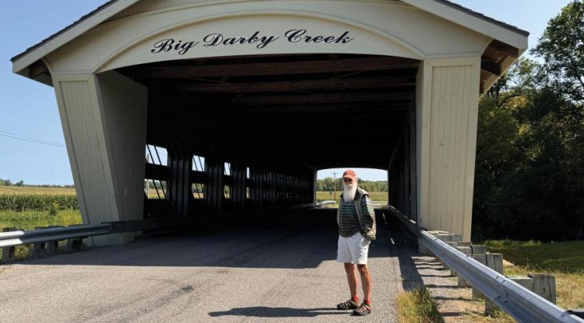 Steve Stolte posing with a covered bridge