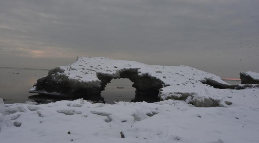 Remnants of Lake Erie’s ice hang on as late as March, with wind, waves, and warming water developing arches and caves along the shoreline.