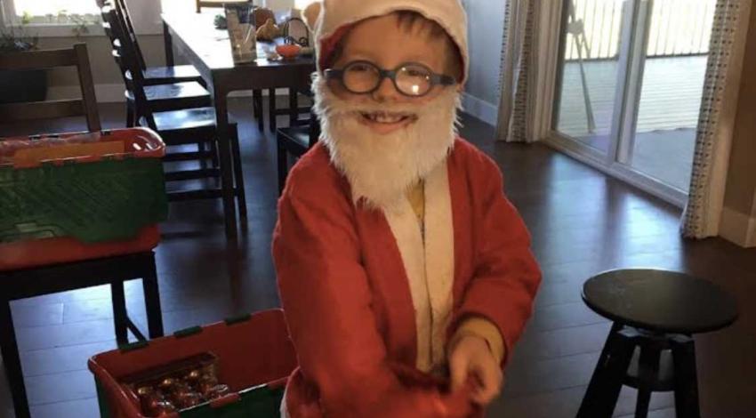 smiling little boy in Santa suit
