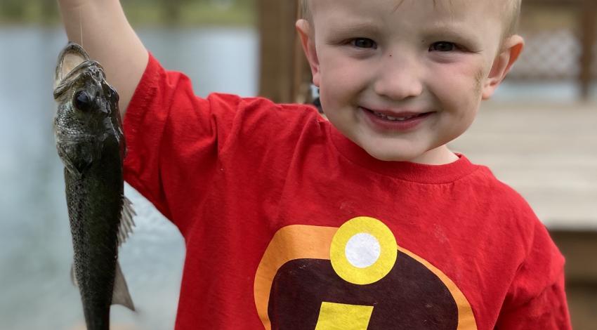 Little boy holding a fish