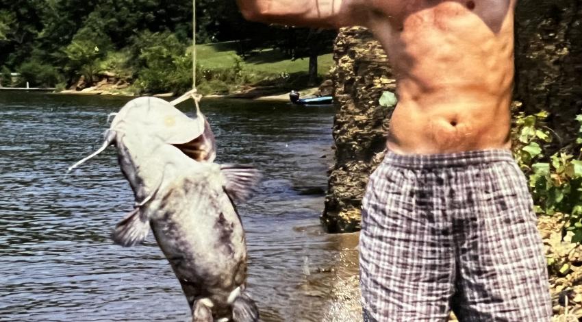 Man smiling holding a fish