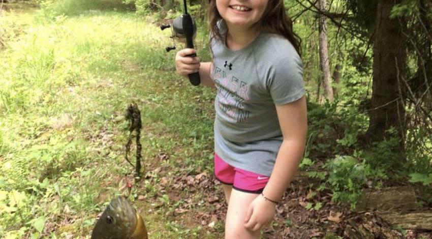 girl smiling holding fish