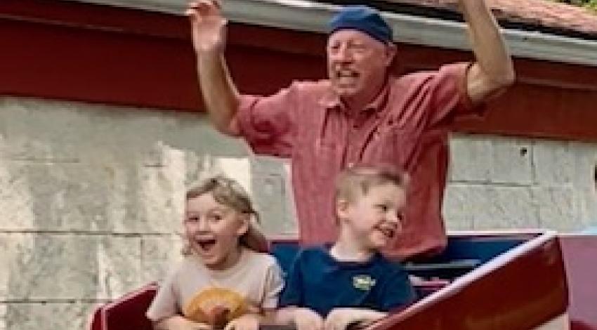 Man and two boys on roller coaster
