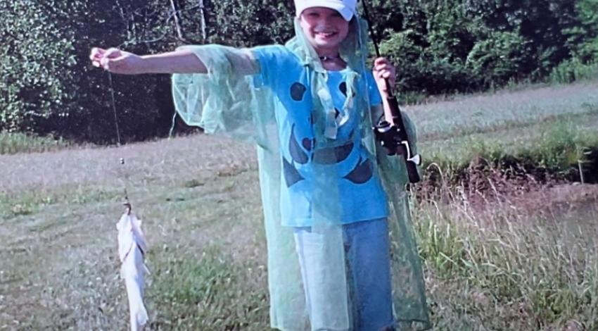 girl smiling holding fish