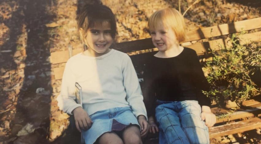 two little girls sitting on bench