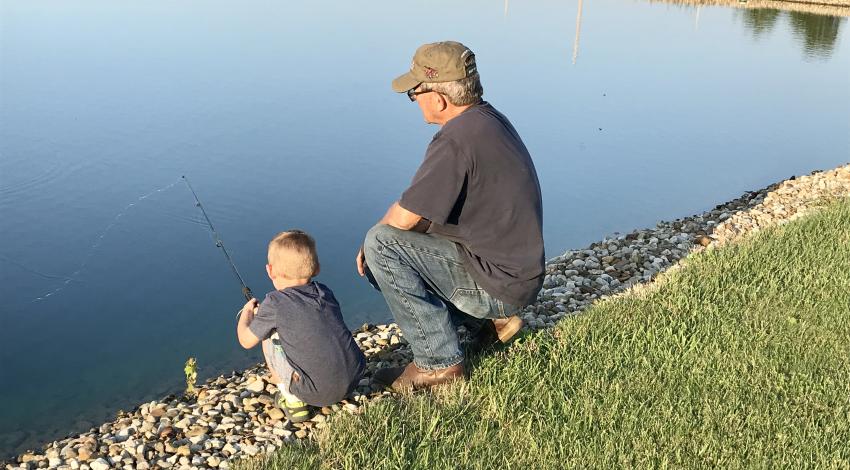 little boy and his grandpa fishing