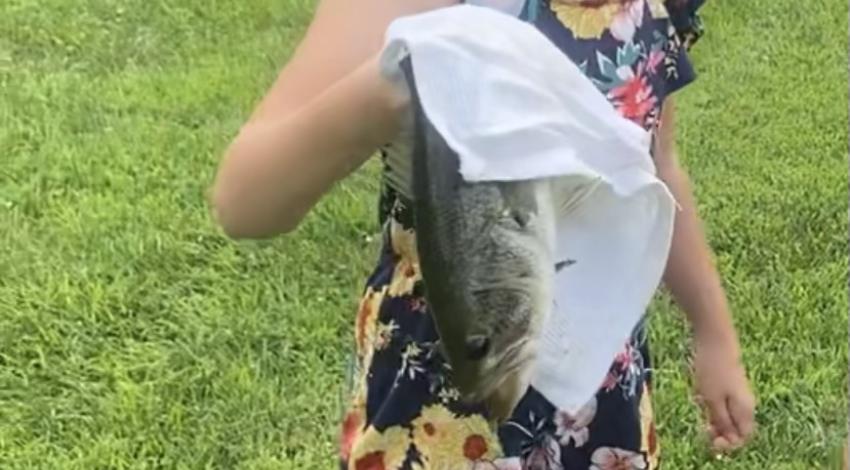 girl smiling holding a fish