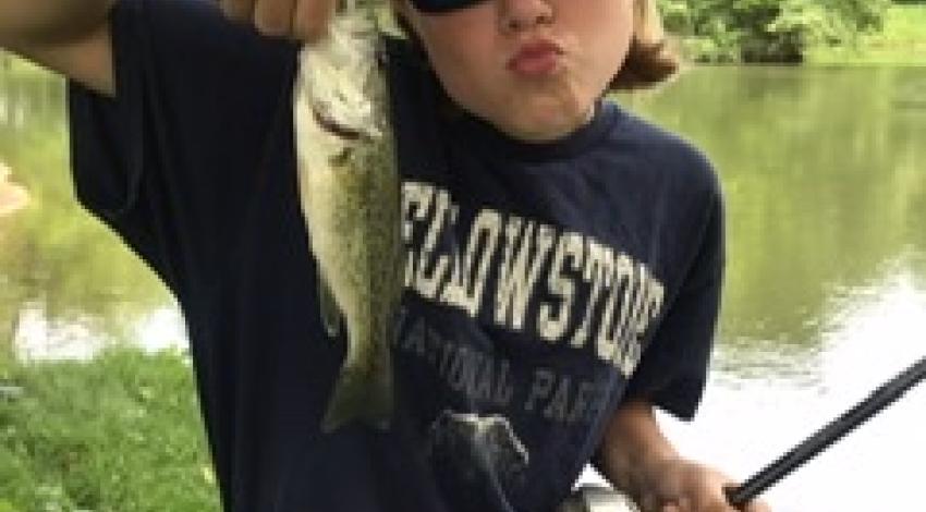 kid holding a fish