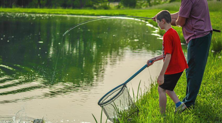 boy fishing with his grandpa