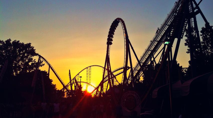 roller coasters in front of sunset