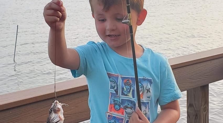 Little boy holding a fish