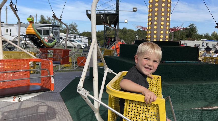 little boy on carnival ride