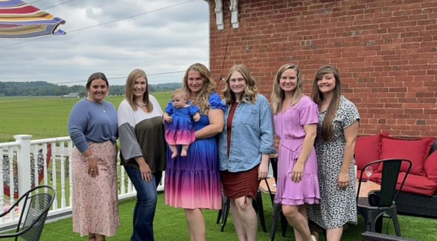 group of women, one holding a baby