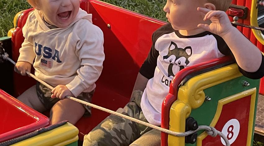 two little boys on kids' coaster