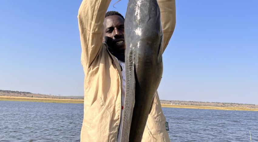 A guide holds up a large fish