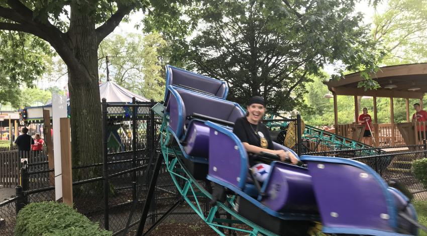 Adult and child on purple roller coaster