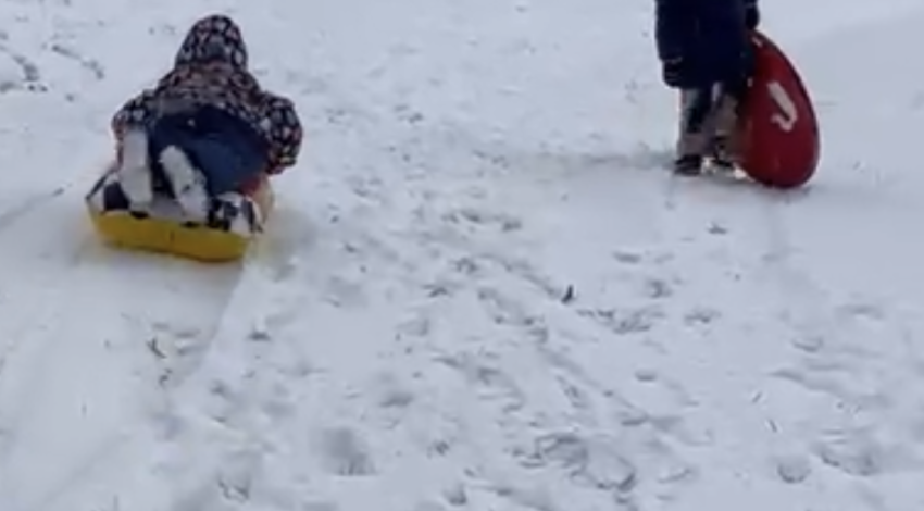 two children sledding 