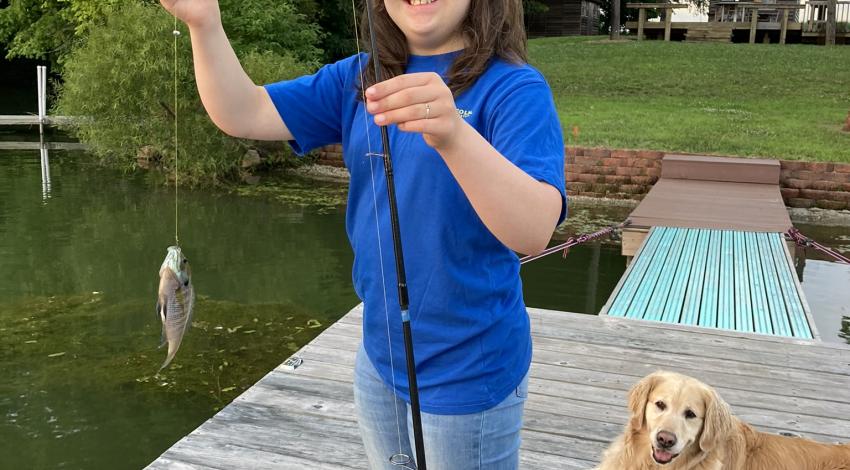 girl smiling holding fish