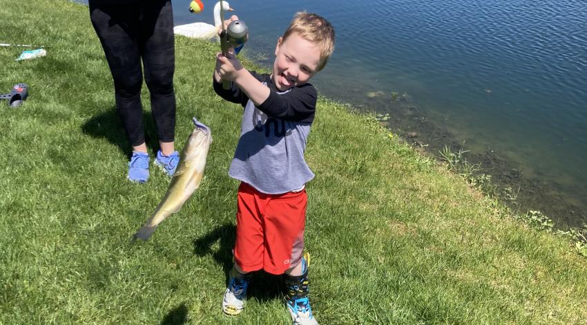 Little boy holding a fish