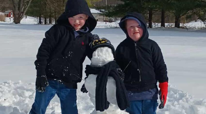 two kids with snowman