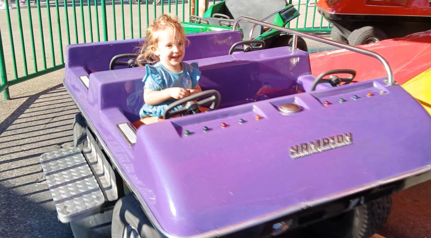 little girl on kids' coaster
