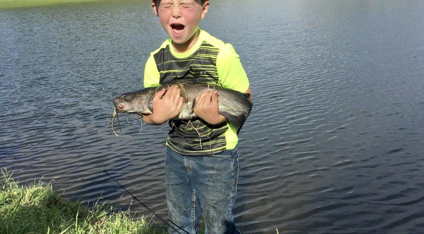 boy holding a fish